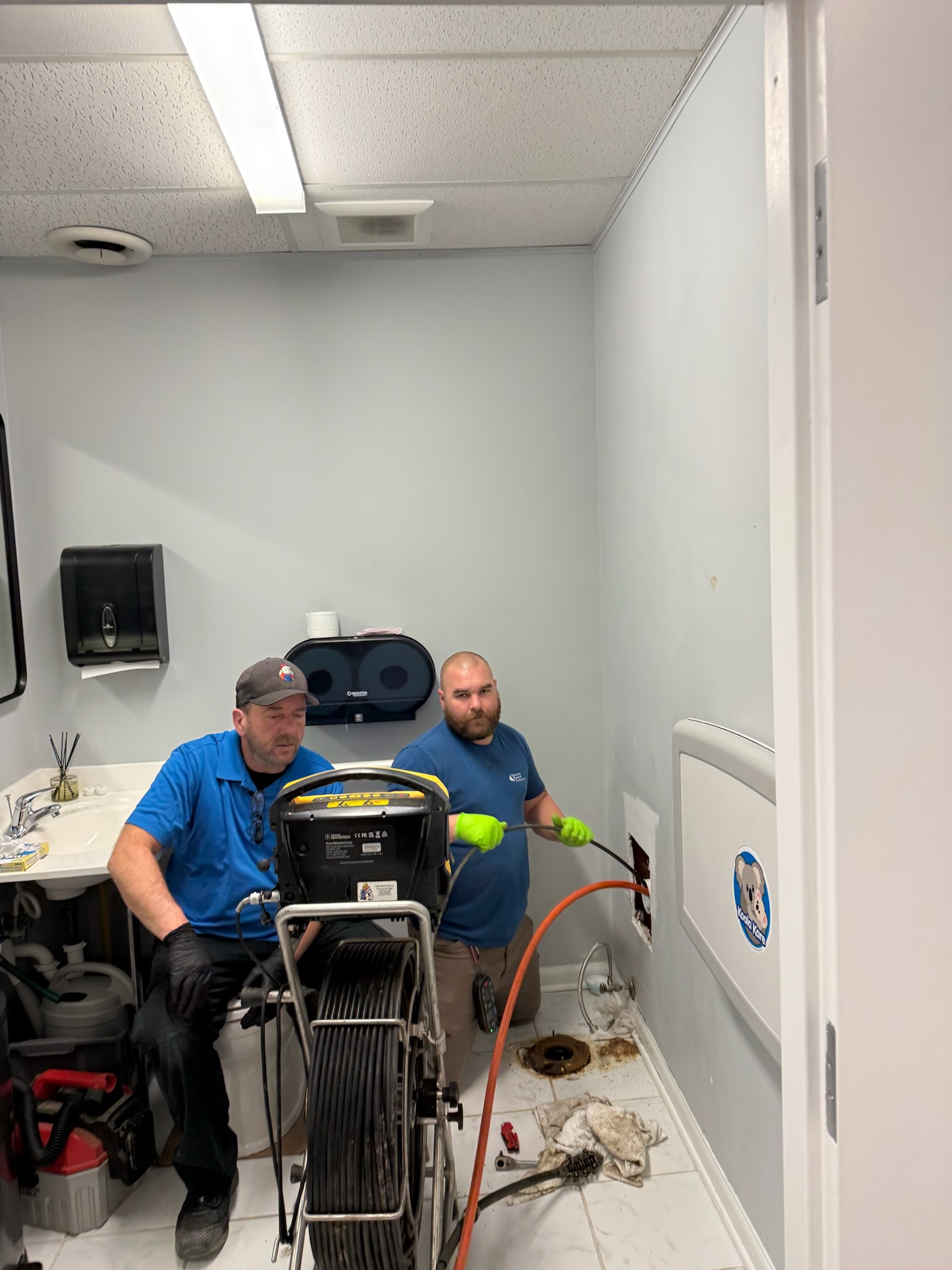 Wooley technicians at the cleanout — push-camera reel deployed, scoping a Central Ohio lateral